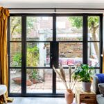 Closed door with black sash windows overlooking the garden