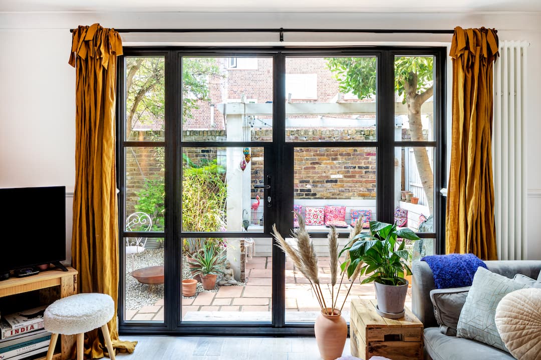 Closed door with black sash windows overlooking the garden