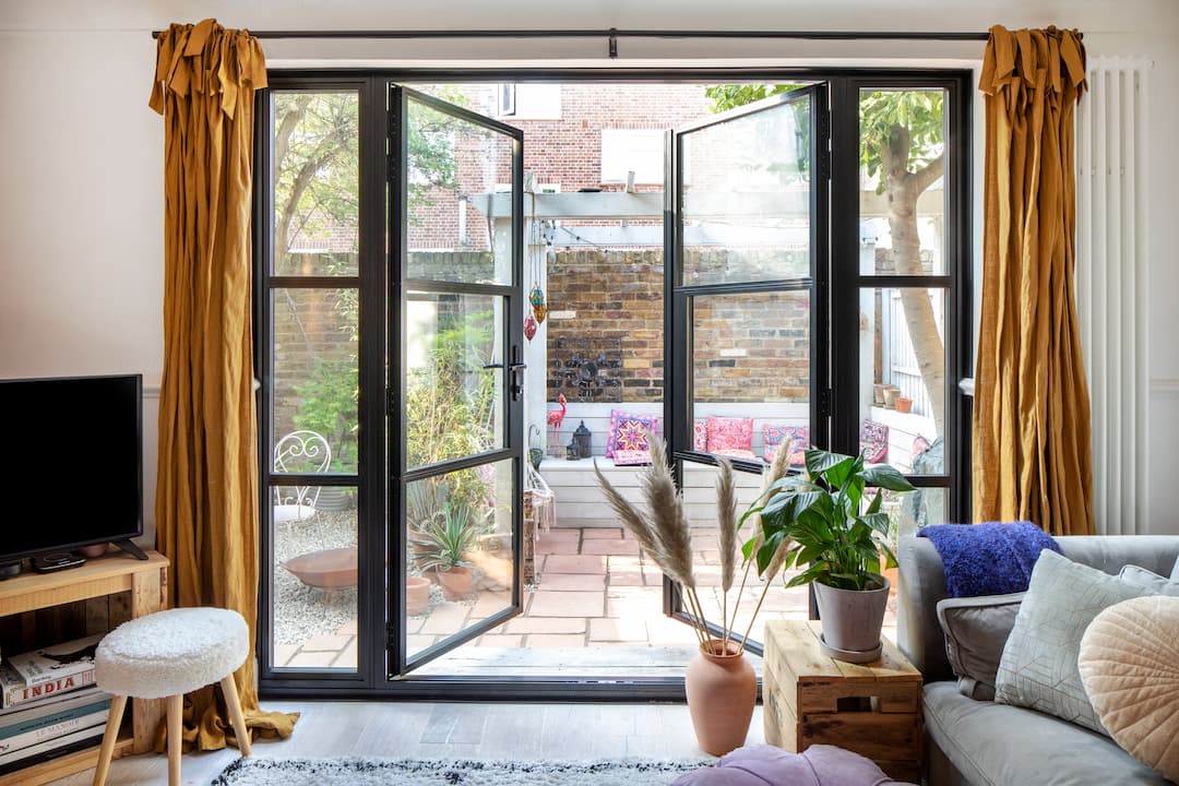 french doors opening onto urban courtyard garden