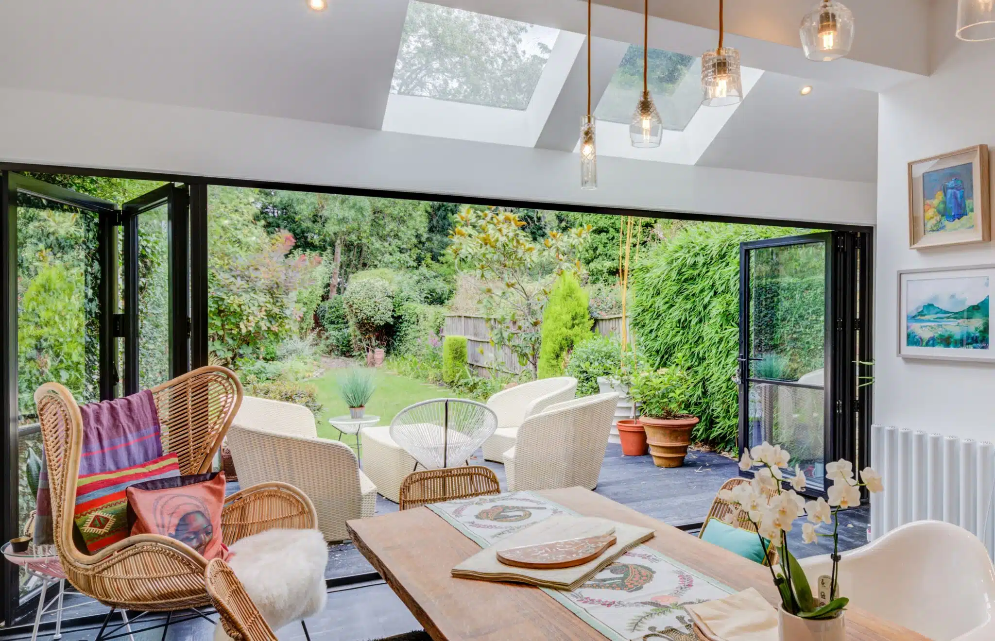 living and dining space with bifold doors opening out into garden and patio space