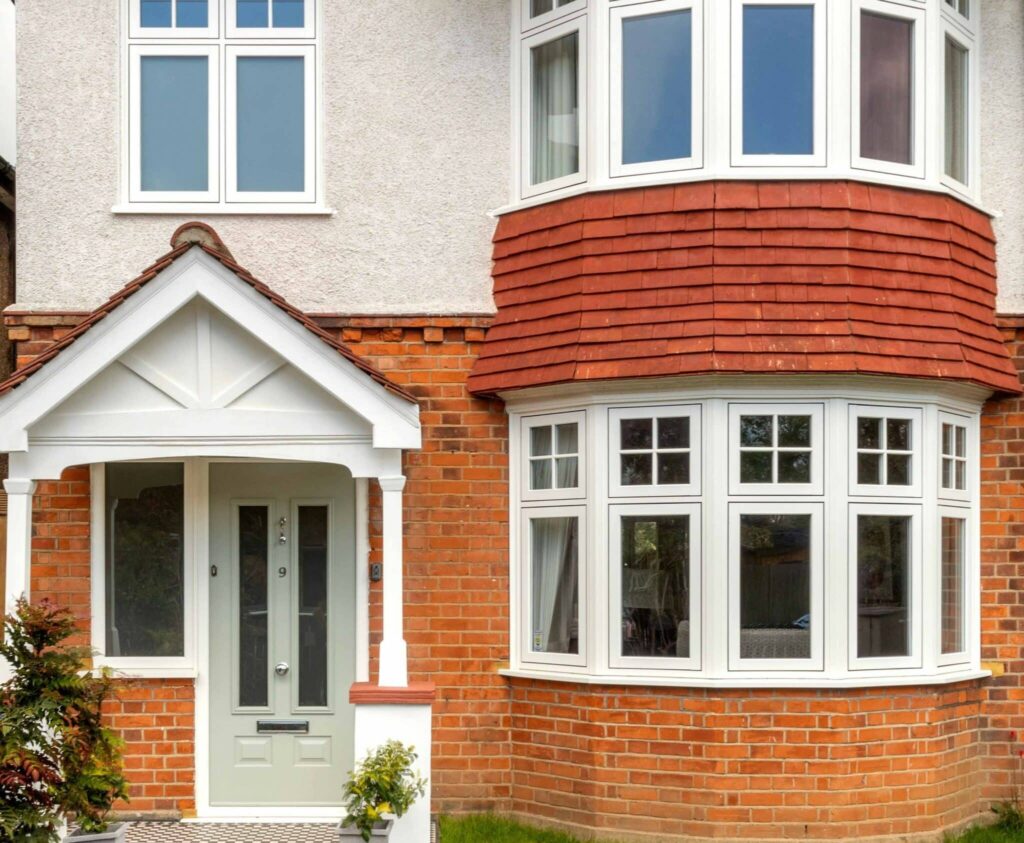 red brick edwardian style house with an off-white composite front door